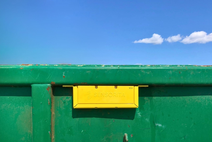 outdoor green bin building sitting blue water bench sign empty wooden city large street boat ocean