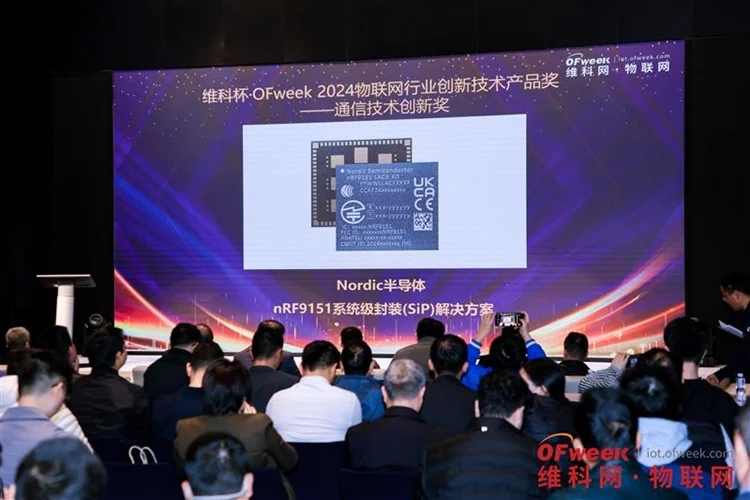 a group of people posing for a photo in front of a computer screen